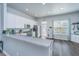 Bright kitchen with white cabinets, a breakfast bar, stainless steel appliances, and a door leading to the outside at 401 Forsythia Ave, Summerville, SC 29483