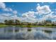 Picturesque pond reflecting the surrounding trees and sky, creating a peaceful community atmosphere at 401 Forsythia Ave, Summerville, SC 29483