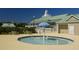 Community splash pad with umbrella feature and tables, situated near a clubhouse with manicured landscaping at 401 Forsythia Ave, Summerville, SC 29483