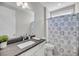 Well-lit bathroom featuring a dark countertop and a patterned shower curtain at 4075 Aspera Dr, Summerville, SC 29483