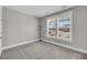 Bright bedroom with neutral carpet and paint and a large window with blinds at 4075 Aspera Dr, Summerville, SC 29483