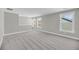 Bright bonus room with neutral paint, carpet, trim, and three large windows at 4075 Aspera Dr, Summerville, SC 29483