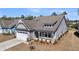 Charming single-Gathering home featuring a covered front porch, attached two-car garage, and manicured landscaping at 4075 Aspera Dr, Summerville, SC 29483