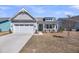 Inviting home featuring a quaint front porch, two-car garage, and manicured lawn at 4075 Aspera Dr, Summerville, SC 29483