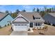 Charming home featuring a two-car garage, front porch, and lovely landscaping at 4075 Aspera Dr, Summerville, SC 29483