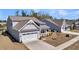 Angle view of gray house with a two-car garage, front porch, and simple landscape at 4075 Aspera Dr, Summerville, SC 29483
