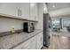 Bright kitchen featuring granite countertops, stainless steel appliances, and sleek white cabinets at 4075 Aspera Dr, Summerville, SC 29483