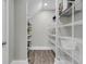 Walk-in pantry featuring wood-look floors and ample white wire shelving for optimal storage and organization at 4075 Aspera Dr, Summerville, SC 29483
