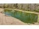 Scenic pond with a fountain, landscaped edges, and natural shoreline; showcasing community's natural beauty at 4075 Aspera Dr, Summerville, SC 29483