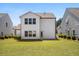 Back of the house with manicured green lawn, surrounded by shrubs, and a concrete patio at 410 Avocet Dr, Summerville, SC 29486