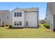 Exterior of home with level lawn, green shrubs, and concrete patio at 410 Avocet Dr, Summerville, SC 29486