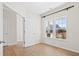Empty bedroom with hardwood floors, bright window and view to the outside at 410 Avocet Dr, Summerville, SC 29486