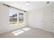 A bright bedroom boasts natural light through the windows and features plush carpeting at 410 Avocet Dr, Summerville, SC 29486