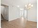 Bright entryway with hardwood floors, chandelier and view to a front door and staircase at 410 Avocet Dr, Summerville, SC 29486