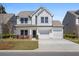 Charming two-story home featuring a two-car garage, well-maintained lawn, and inviting front porch at 410 Avocet Dr, Summerville, SC 29486