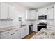 Bright kitchen features stainless steel appliances, white cabinets and granite countertops at 410 Avocet Dr, Summerville, SC 29486