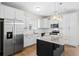 Bright kitchen features stainless steel appliances, white cabinets, granite countertops, and center island at 410 Avocet Dr, Summerville, SC 29486