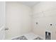 Small laundry room with patterned tile floor, one wire rack shelf, and white walls at 410 Avocet Dr, Summerville, SC 29486