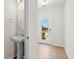 Stylish powder room with pedestal sink, oval mirror and hardwood floors at 410 Avocet Dr, Summerville, SC 29486