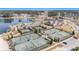 Beautiful aerial view of community tennis courts, pool, and lakeside amenities in a resort setting at 415 Four Seasons Blvd, Summerville, SC 29486