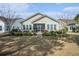 Landscaped backyard featuring a screened-in porch with outdoor seating, perfect for relaxation at 415 Four Seasons Blvd, Summerville, SC 29486