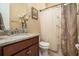 Cozy bathroom with a granite vanity, decorative shower curtain, and neutral tones at 415 Four Seasons Blvd, Summerville, SC 29486