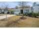 Charming home featuring a two-car garage, well-manicured lawn, and cozy front porch at 415 Four Seasons Blvd, Summerville, SC 29486