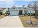 Charming single-story home featuring a two-car garage, landscaped yard, and well-manicured lawn at 415 Four Seasons Blvd, Summerville, SC 29486