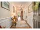 Elegant hallway with hardwood floors, wainscoting, decorative lighting and artwork leading to open living spaces at 415 Four Seasons Blvd, Summerville, SC 29486