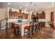 Beautiful kitchen featuring dark wood cabinets, granite countertops, pendant lights, and stainless steel appliances at 415 Four Seasons Blvd, Summerville, SC 29486