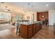 Open concept kitchen with a large granite island, dark wood cabinets and stainless appliances at 415 Four Seasons Blvd, Summerville, SC 29486