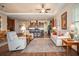 Open-concept living room with hardwood floors and seamless flow into kitchen at 415 Four Seasons Blvd, Summerville, SC 29486