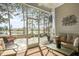 Relaxing screened porch with lake views, seating and plenty of natural light at 415 Four Seasons Blvd, Summerville, SC 29486