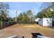 Large backyard showcasing newly installed fence, green foliage, and a storage shed at 4625 Durant Ave, North Charleston, SC 29405