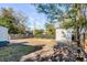 Image of the spacious backyard, featuring green foliage, a storage shed, and a newly installed fence at 4625 Durant Ave, North Charleston, SC 29405