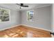 Bright bedroom with hardwood floors, updated ceiling fan, and natural light at 4625 Durant Ave, North Charleston, SC 29405