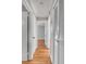 Hallway with hardwood floors leading to rooms with doors and great architectural features at 4625 Durant Ave, North Charleston, SC 29405