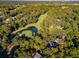Scenic aerial view of golf course homes nestled in lush greenery, with a serene pond and a beautiful golf green at 5208 Holly Forest, Hollywood, SC 29449