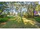 Lush backyard with mature trees, ample space for outdoor activities, and a serene setting at 5208 Holly Forest, Hollywood, SC 29449
