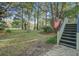 Expansive backyard featuring mature trees, lush lawn, and stairway leading to the home at 5208 Holly Forest, Hollywood, SC 29449