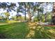 Picturesque backyard with mature trees, green lawn, and a charming firepit area overlooking the water at 5208 Holly Forest, Hollywood, SC 29449