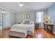 Spacious bedroom with hardwood floors, a king-sized bed, and plenty of natural light at 5208 Holly Forest, Hollywood, SC 29449