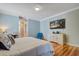 Bright bedroom with coastal decor, wood floors, and a large TV at 5208 Holly Forest, Hollywood, SC 29449