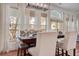 Bright dining room with abundant natural light, featuring a formal dining table and stylish lighting fixture at 5208 Holly Forest, Hollywood, SC 29449