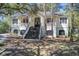 Charming two-story home with a welcoming front porch and manicured landscaping in a wooded setting at 5208 Holly Forest, Hollywood, SC 29449