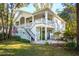 Beautiful two-story home with a large porch, landscaped yard, stairs, and a detached garage at 5208 Holly Forest, Hollywood, SC 29449