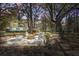 Relaxing fire pit area with Adirondack chairs and a view of the home's exterior at dusk at 5208 Holly Forest, Hollywood, SC 29449