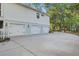 Spacious three-car garage, perfect for car enthusiasts or extra storage, with well-manicured landscaping at 5208 Holly Forest, Hollywood, SC 29449