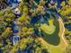 Aerial view of a golf course with a lake and beautiful surroundings and well maintained landscaping at 5208 Holly Forest, Hollywood, SC 29449