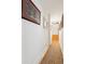 Bright hallway featuring wood floors, neutral paint, and curated wall art at 5208 Holly Forest, Hollywood, SC 29449
